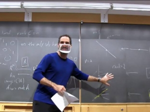 Professor Ezra Miller using a see through face mask to teach math class.